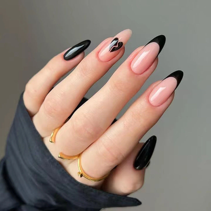 Hand with black and pink nail design on a gray background